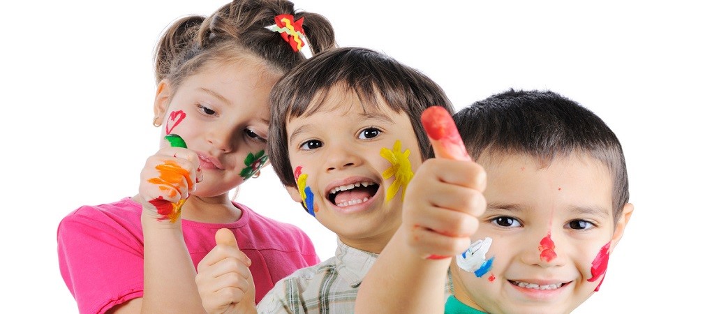 Messy children with paint on their hands and faces with thumbs up